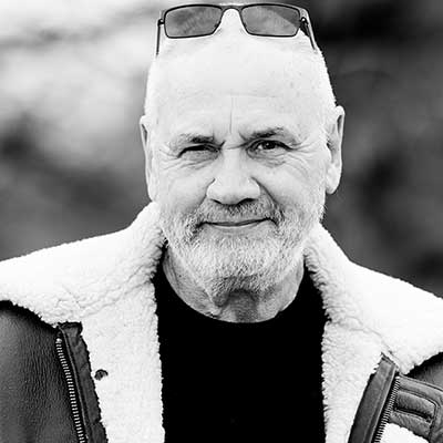 A black and white photo of a male client in a warm winter jacket