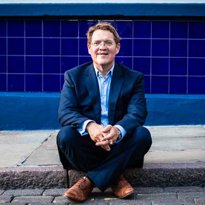 A male sat in front of a blue tiled wall in the Lace Market, Nottingham