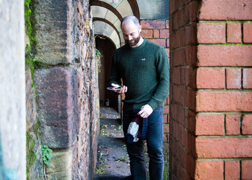 Dating photo shoot client browsing through Tinder on his phone