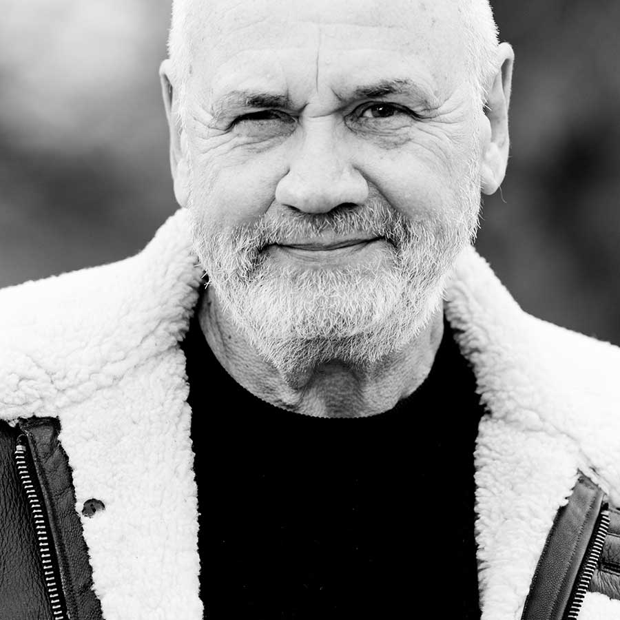 Male in a thick sheepskin jacket looking at the camera