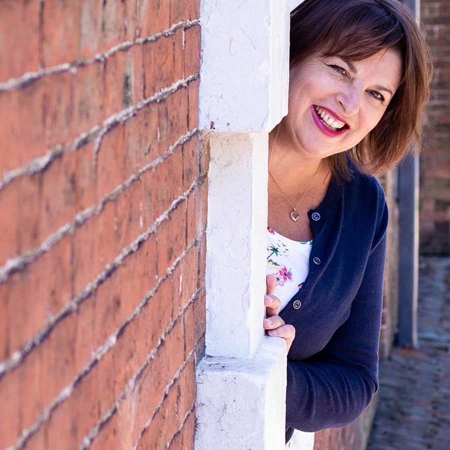 Female peeking around a doorway with red lipstick on