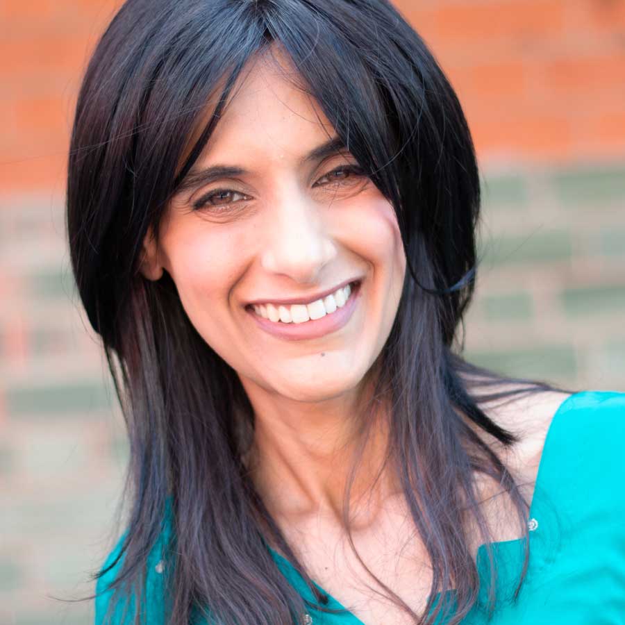 Female smiling in a bright turquoise outfit