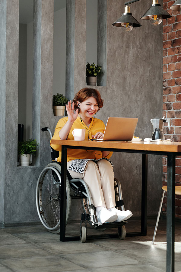 Woman sitting in wheelchair during an online video call with her date