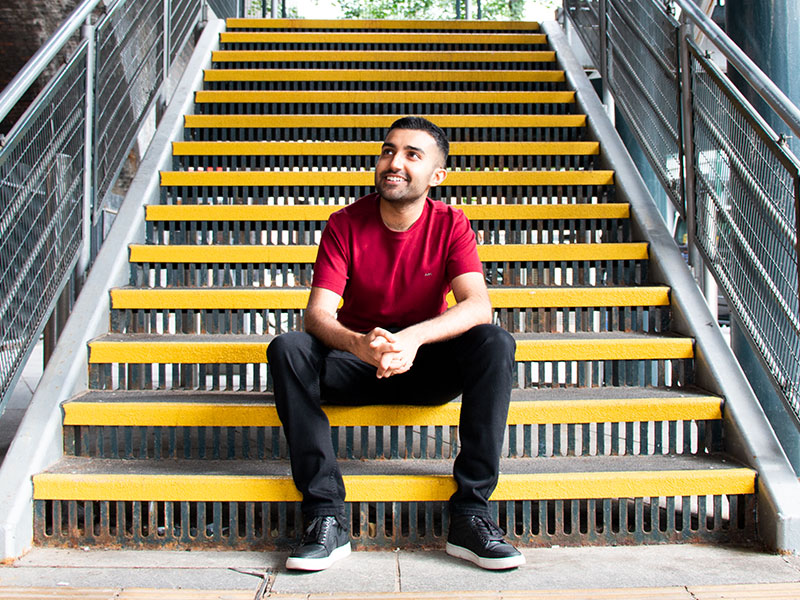 A man sat on yellow steps in Nottingham