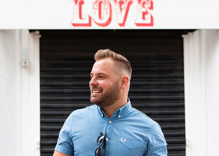 Dating photo of man standing in front of Love sign