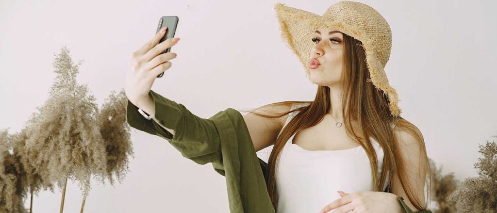 Are we living in a selfie state? Woman taking selfie and pouting