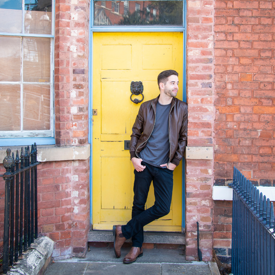 Male stood in yellow doorway
