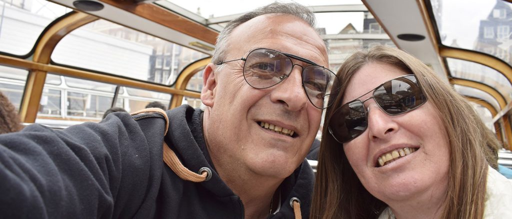 Selfie of a man and women on top of a bus