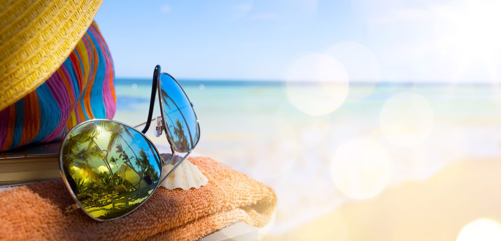 Sunglasses and towel on a beach at a singles holiday