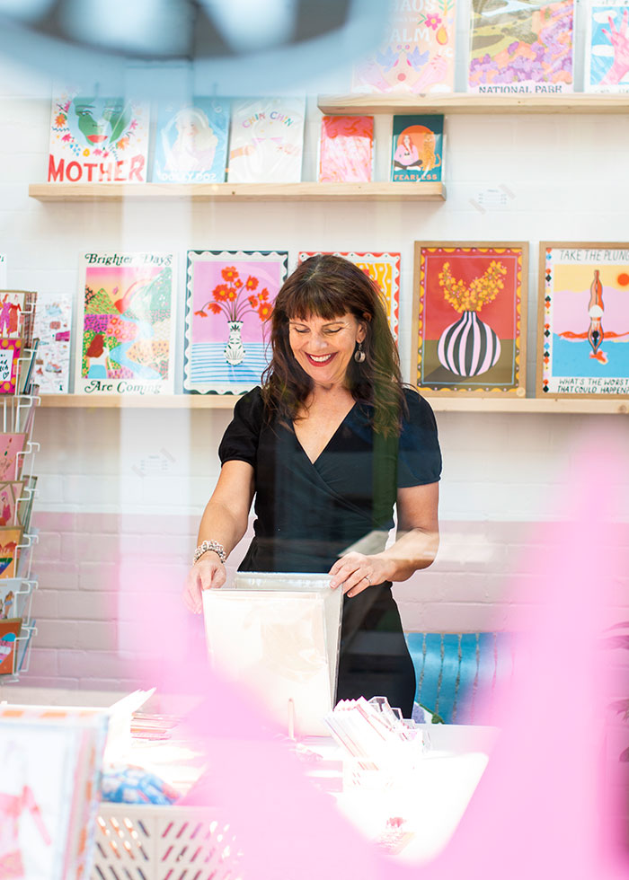 Female looking through artwork in a shop. - Captured by Dating Profile Photographer, Gemma Wilks | We Just Clicked